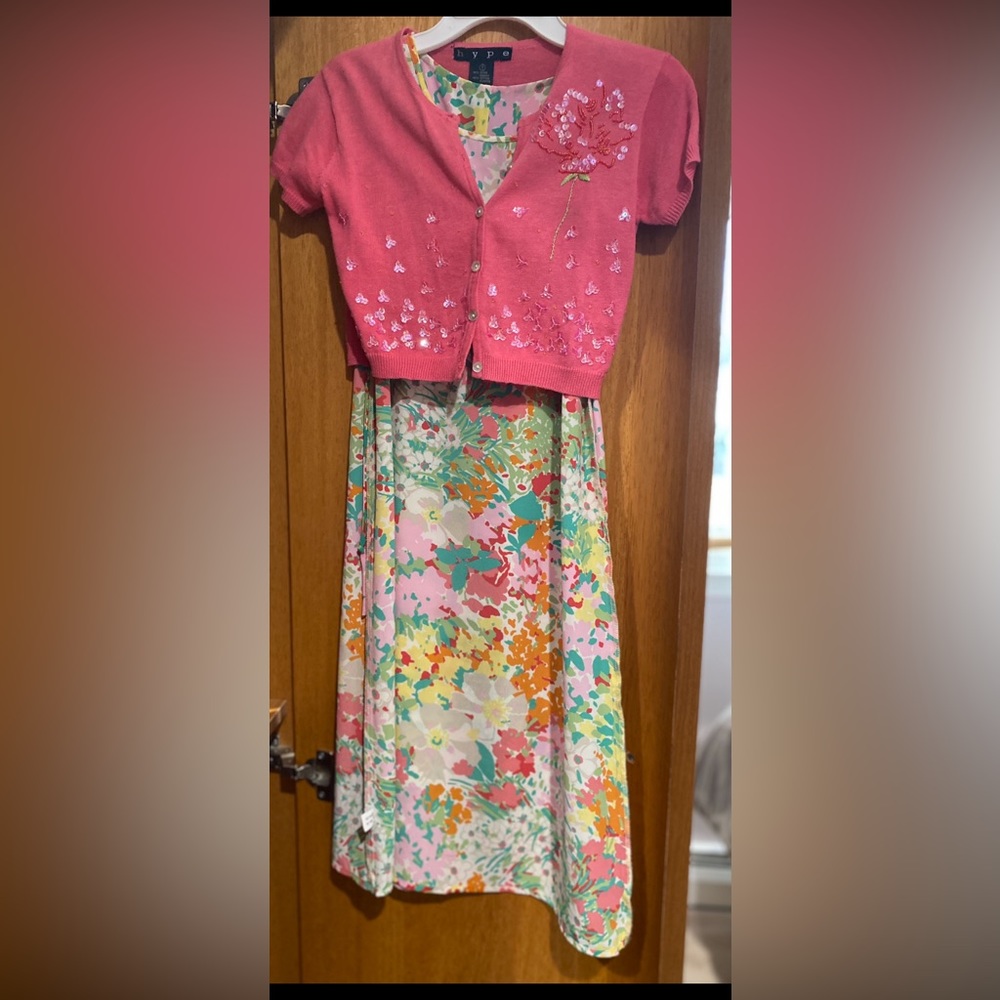 Girls sleeveless dress with short sleeve sweater .